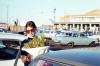 Caroline holding bunch of Cape flowers at Jan Smuts airport - early 1969
